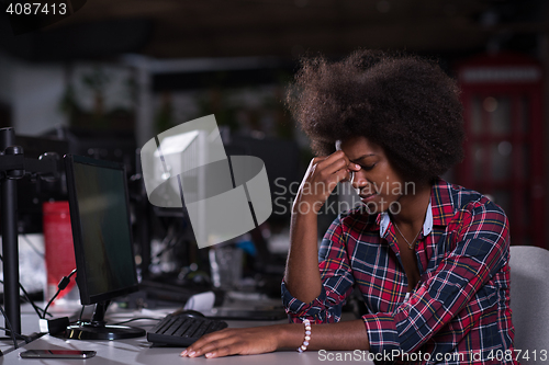 Image of a young African American woman feels tired in the modern office