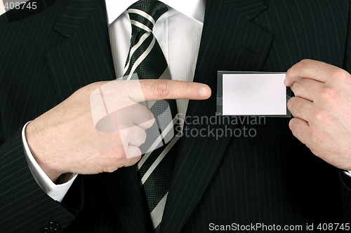 Image of Salesman pointing to his nametag