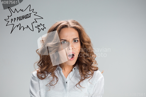 Image of Portrait of young woman with shocked facial expression