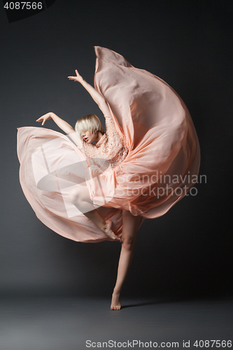 Image of Woman dancing in chiffon dress