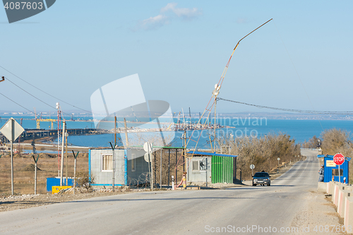 Image of Taman, Russia - November 5, 2016: Construction of a bridge across the Kerch Strait, the control checkpoint on the road leading to the building, at the shoreline of the Taman peninsula, as of November 