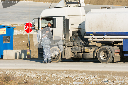 Image of Taman, Russia - November 5, 2016: Verification of documents from the driver tank truck at security checkpoint at vezde the protected area