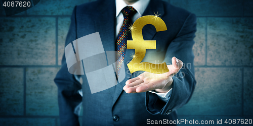 Image of Trader Holding A Golden British Pound Sterling Symbol