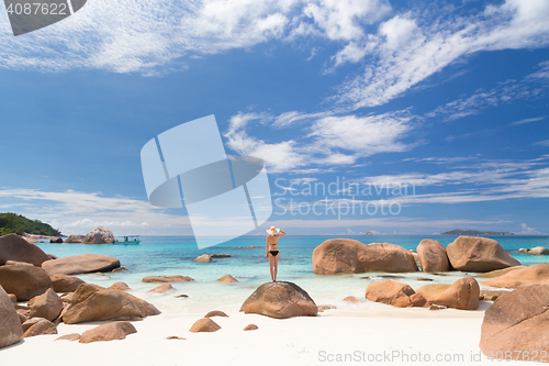 Image of Woman enjoying Anse Lazio picture perfect beach on Praslin Island, Seychelles.