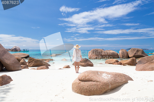 Image of Woman enjoying Anse Lazio picture perfect beach on Praslin Island, Seychelles.