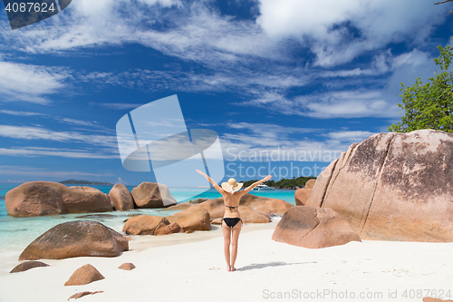 Image of Woman enjoying Anse Lazio picture perfect beach on Praslin Island, Seychelles.