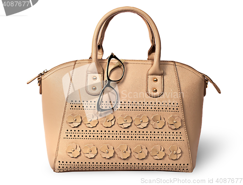 Image of Elegant beige handbag and glasses