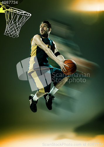 Image of Full length portrait of a basketball player with ball