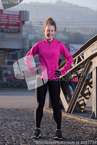 Image of woman  stretching before morning jogging