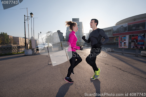 Image of couple warming up before jogging