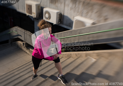 Image of woman  stretching before morning jogging