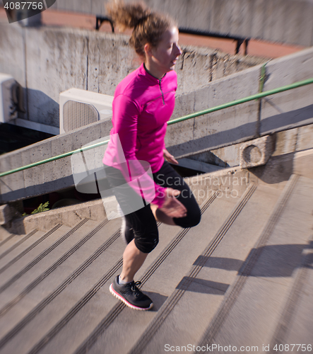 Image of woman jogging on  steps