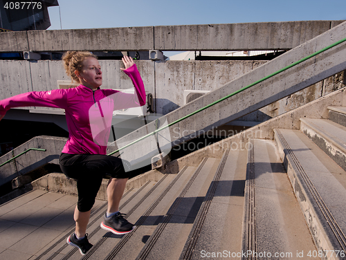 Image of woman jogging on  steps