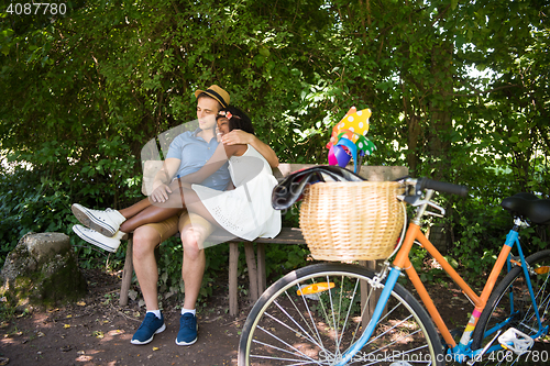 Image of Young multiethnic couple having a bike ride in nature
