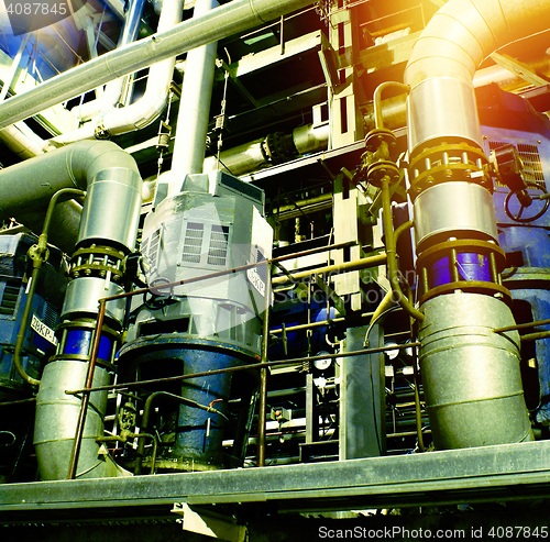 Image of Pipes, tubes, machinery and steam turbine at a power plant