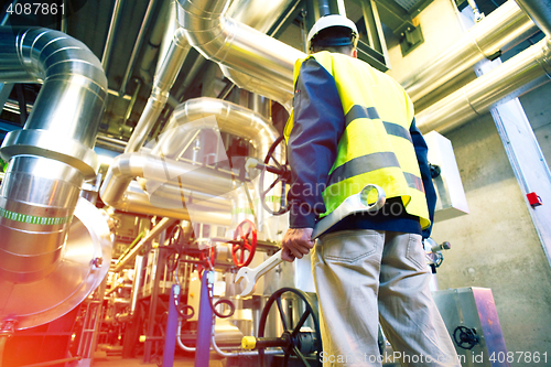 Image of industrial worker with spanner at factory