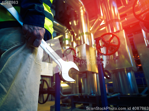 Image of industrial worker with spanner at ?????????? factory 