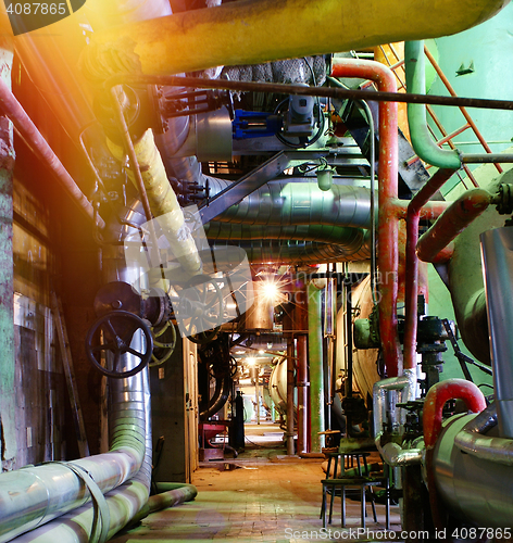 Image of Pipes, tubes, machinery and steam turbine at a power plant