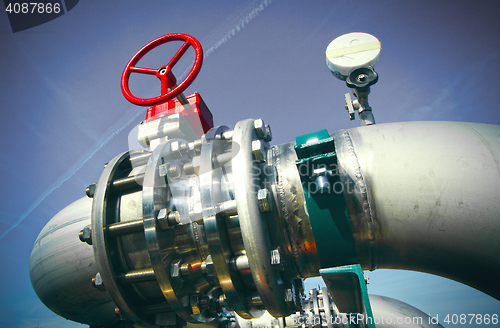 Image of Industrial zone, Steel pipelines and valves against blue sky