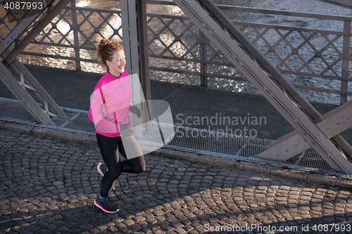 Image of sporty woman jogging on morning