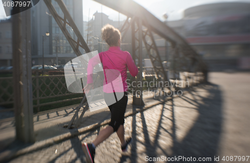 Image of sporty woman jogging on morning