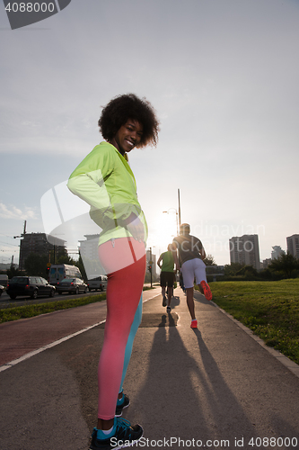 Image of Portrait of sporty young african american woman running outdoors