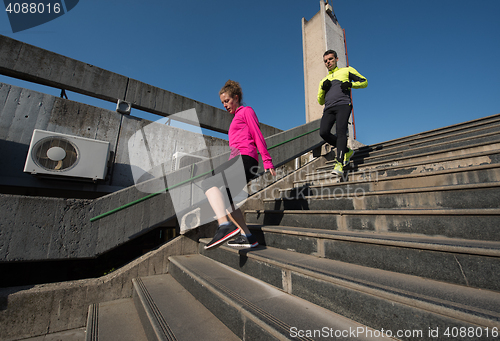 Image of young  couple jogging on steps