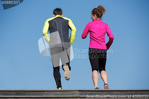 Image of young  couple jogging on steps