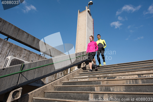 Image of young  couple jogging on steps