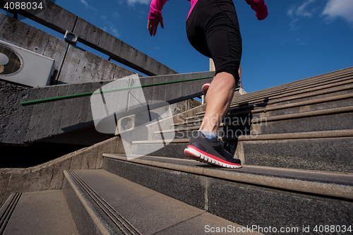 Image of woman jogging on  steps