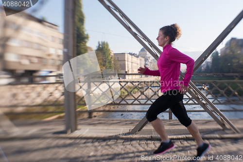 Image of sporty woman jogging on morning