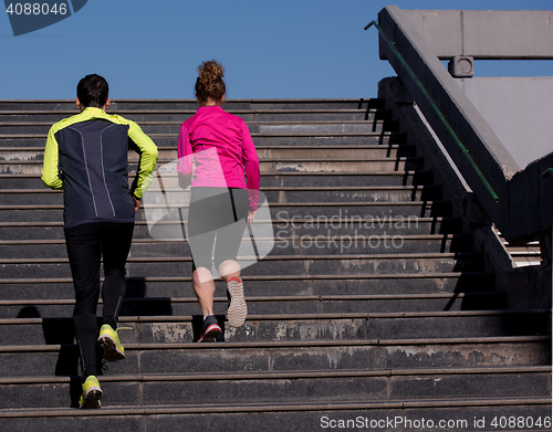 Image of young  couple jogging on steps