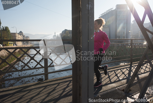 Image of sporty woman jogging on morning