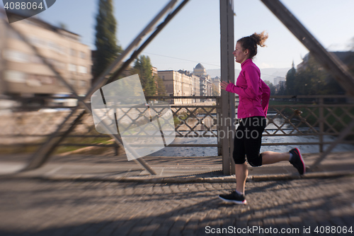 Image of sporty woman jogging on morning