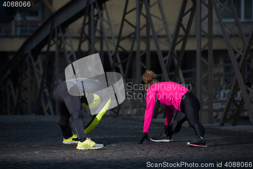 Image of couple warming up before jogging