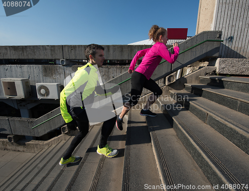 Image of young  couple jogging on steps