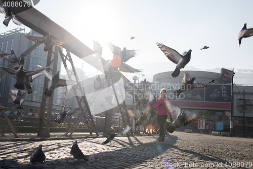 Image of sporty woman jogging on morning