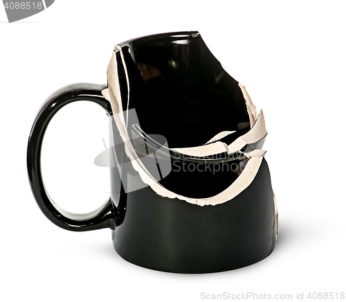 Image of Broken black ceramic cup fragments are inside