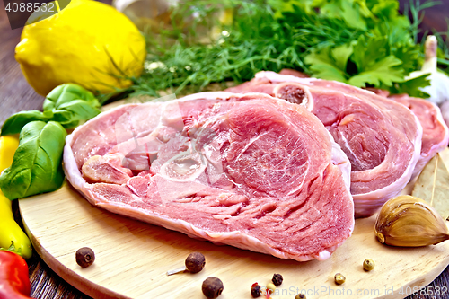 Image of Turkey steak raw with basil on board