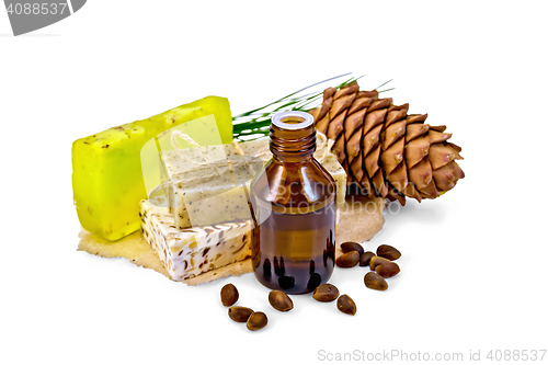 Image of Oil and soap different with cedar nuts and cone