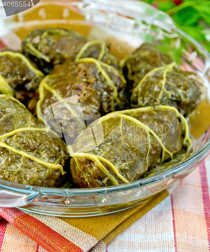 Image of Rhubarb leaves stuffed in glass pan on towel