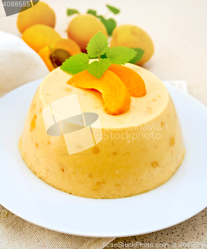 Image of Panna cotta apricot with mint and fruits on napkin