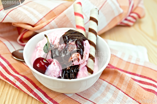 Image of Ice cream cherry with chocolate syrup and waffles