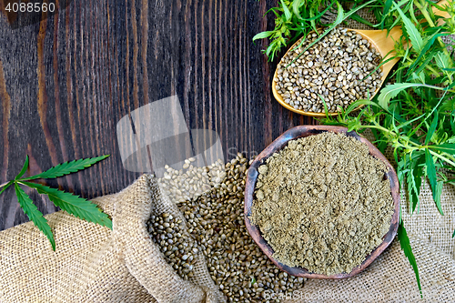 Image of Flour hemp in bowl and seed in wooden spoon on board