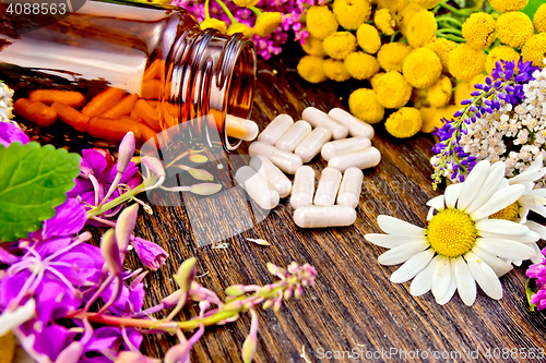 Image of Capsules in open brown jar on board