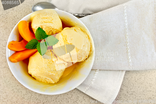 Image of Ice cream apricot in white bowl on table top