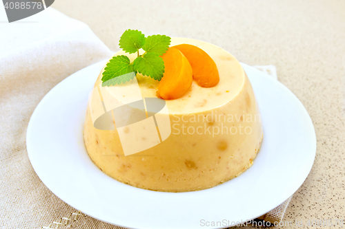 Image of Panna cotta apricot with mint on table