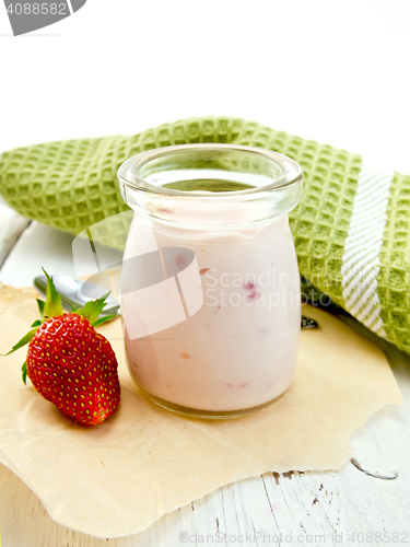 Image of Yogurt with strawberries in jar on light board
