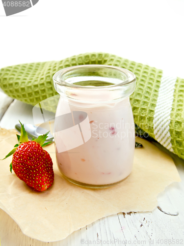 Image of Yogurt with strawberries in jar on light board