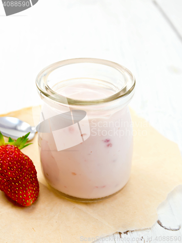 Image of Yogurt with strawberries in jar on parchment